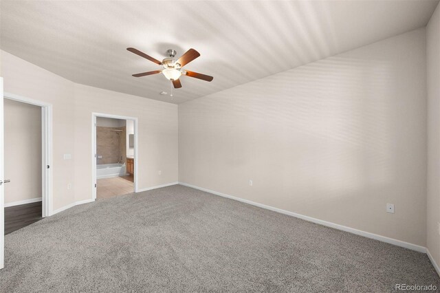 unfurnished bedroom with carpet floors, baseboards, ensuite bathroom, and a ceiling fan