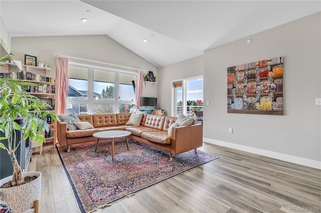 living room with hardwood / wood-style flooring and vaulted ceiling