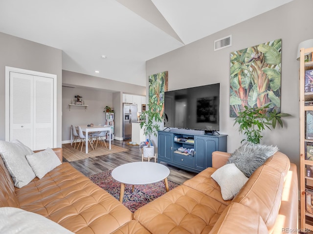 living room featuring hardwood / wood-style floors and vaulted ceiling