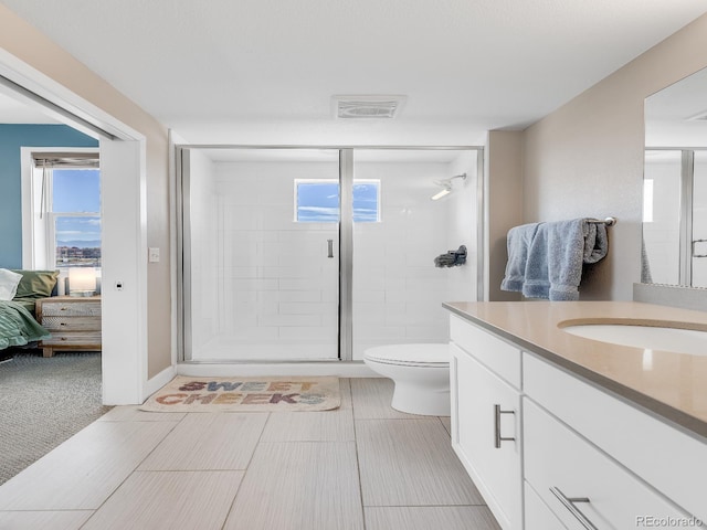 bathroom with vanity, toilet, and a shower with shower door