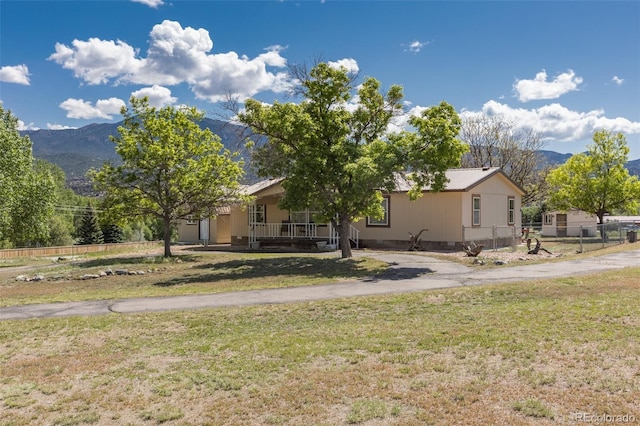 246 Loop Dr, Howard, CO 81233 - view of front of home with a mountain view, a porch, and asphalt driveway