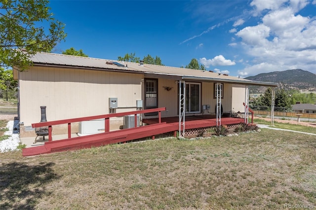 246 Loop Dr, Howard, CO 81233 - back of property with a deck with mountain view and metal roof