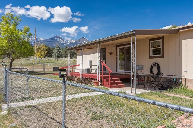 246 Loop Dr, Howard, CO 81233 - view of front of house with a mountain view, a patio, and central AC unit
