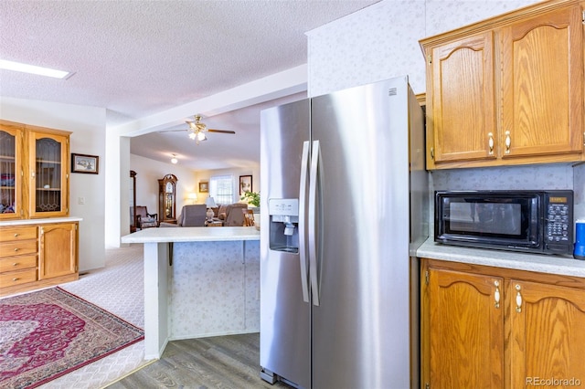 246 Loop Dr, Howard, CO 81233 - kitchen with stainless steel fridge with ice dispenser, black microwave, light countertops, light wood-type flooring, and ceiling fan