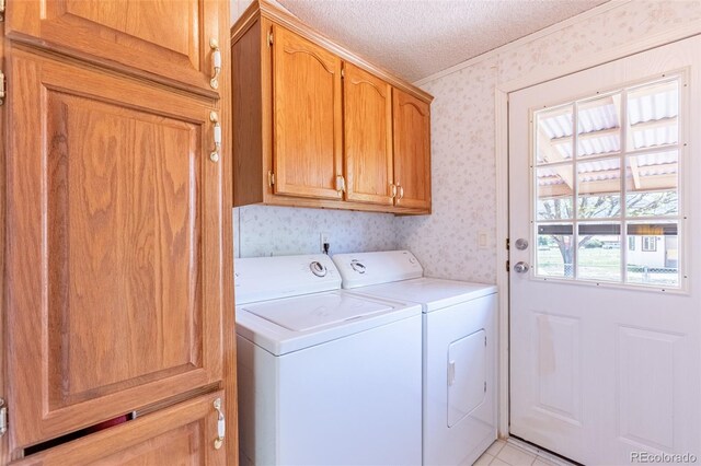 246 Loop Dr, Howard, CO 81233 - laundry room with wallpapered walls, washing machine and dryer, cabinet space, a textured ceiling, and ornamental molding