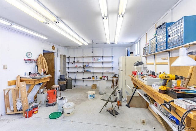 246 Loop Dr, Howard, CO 81233 - garage with a workshop area and freestanding refrigerator