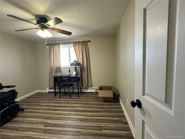 5879 Blue Spruce Ave, Alamosa, CO 81101 - office space with a baseboard heating unit, dark wood-type flooring, and ceiling fan