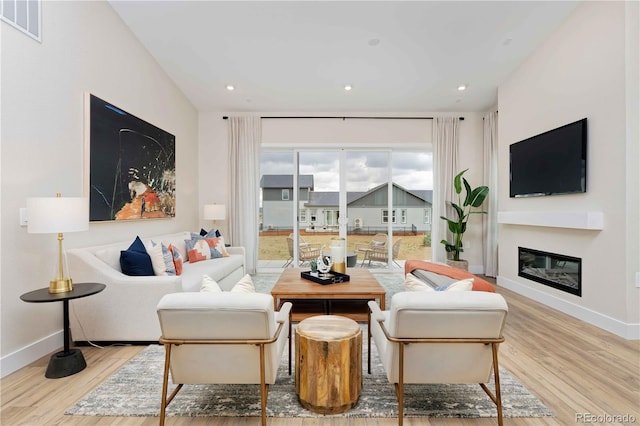 living room with light hardwood / wood-style flooring