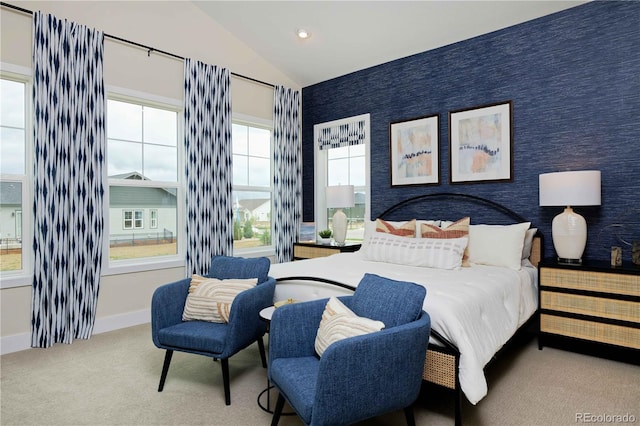 carpeted bedroom with lofted ceiling and multiple windows