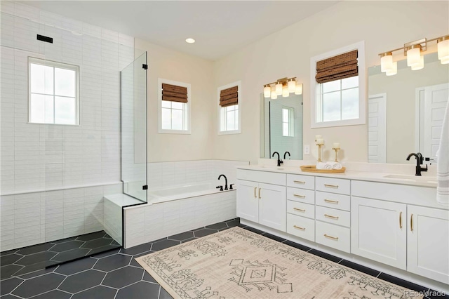 bathroom with vanity, tile patterned floors, and plus walk in shower