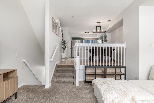 bedroom with stainless steel fridge with ice dispenser, carpet floors, and a notable chandelier