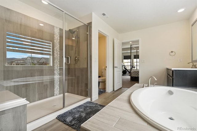 bathroom with a shower with shower door, wood-type flooring, toilet, and vanity