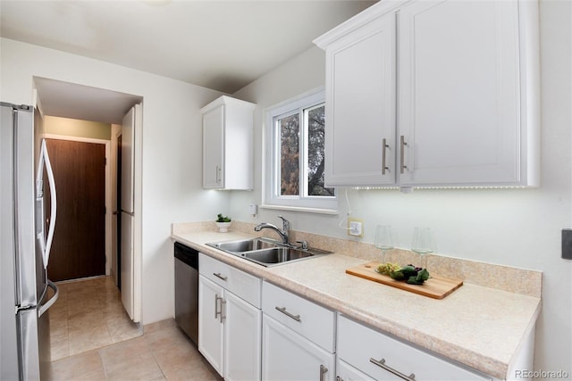 3961 S Uravan St, Aurora, CO 80013 - kitchen with appliances with stainless steel finishes, a sink, light countertops, white cabinets, and light tile patterned flooring