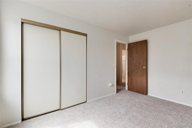 3961 S Uravan St, Aurora, CO 80013 - unfurnished bedroom featuring a closet, carpet flooring, and baseboards