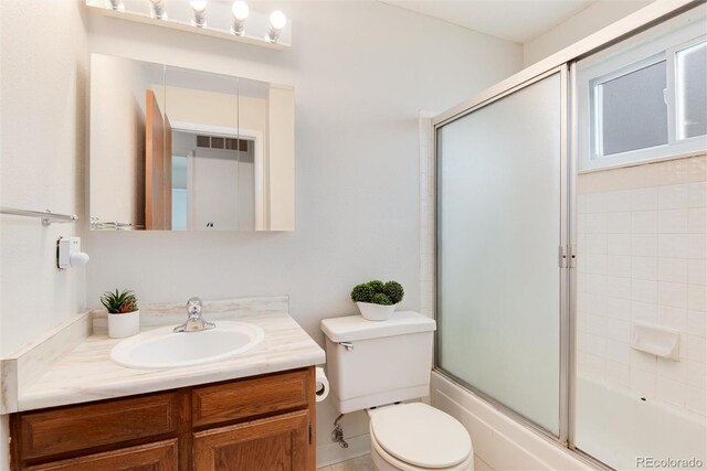 3961 S Uravan St, Aurora, CO 80013 - bathroom featuring vanity, toilet, and enclosed tub / shower combo