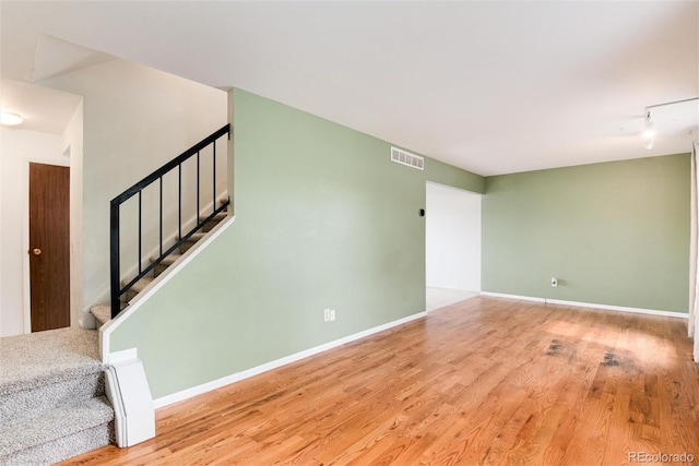 3961 S Uravan St, Aurora, CO 80013 - unfurnished room featuring wood finished floors, stairs, and baseboards
