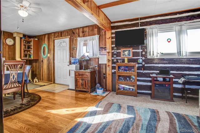 living room featuring wooden walls and ceiling fan