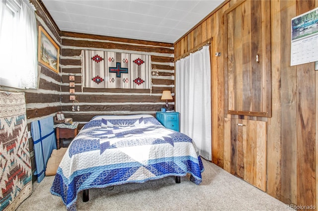 bedroom with carpet flooring and wooden walls