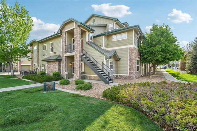 5800 Tower Rd Unit 1201, Denver, CO 80249 - townhome / multi-family property with stone siding, stairs, and a front lawn