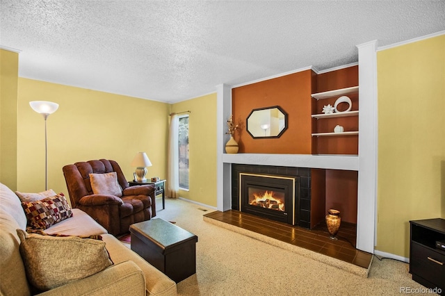 living room with carpet, a textured ceiling, and a tile fireplace