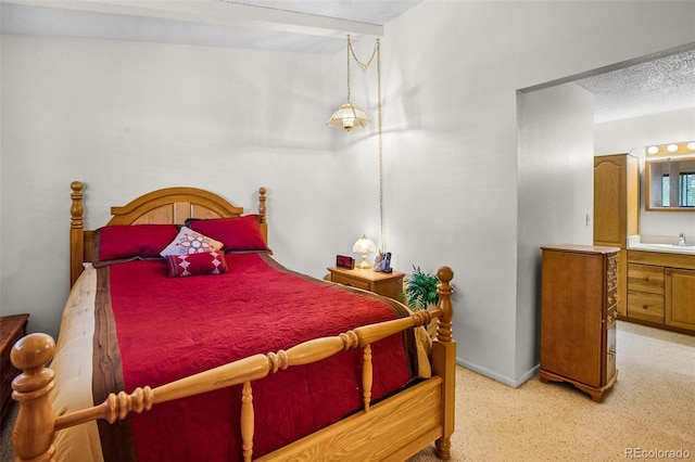 carpeted bedroom featuring a textured ceiling and sink