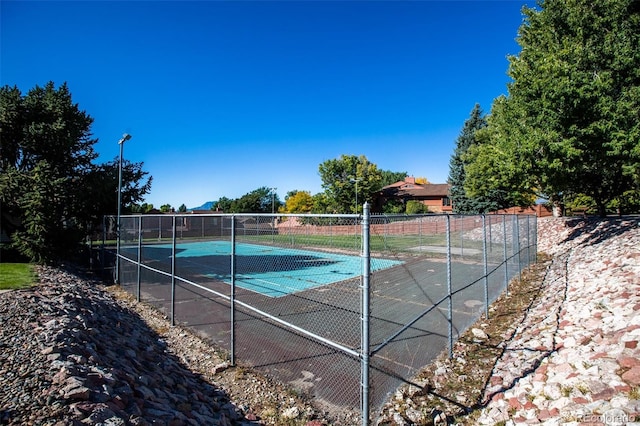 view of pool with tennis court