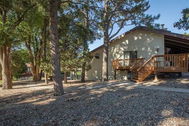 rear view of house with a wooden deck