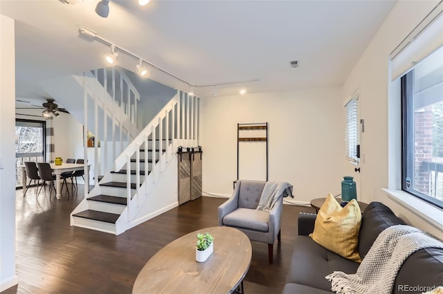 living room with ceiling fan and dark wood-type flooring