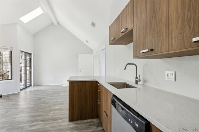 kitchen with stainless steel dishwasher, a sink, beam ceiling, light countertops, and high vaulted ceiling