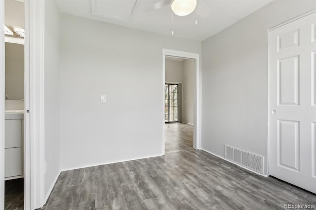 unfurnished bedroom featuring wood finished floors and baseboards