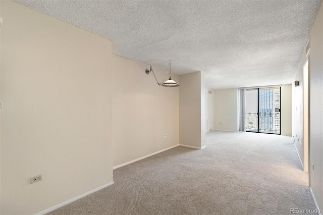 1020 15th St Unit 25D, Denver, CO 80202 - empty room featuring carpet, baseboards, a textured ceiling, and floor to ceiling windows