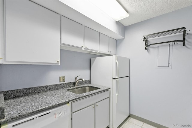 1020 15th St Unit 25D, Denver, CO 80202 - kitchen featuring a sink, white appliances, a textured ceiling, light tile patterned flooring, and light stone countertops