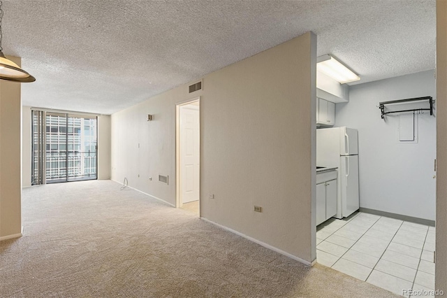 1020 15th St Unit 25D, Denver, CO 80202 - unfurnished room featuring a textured ceiling, light carpet, and baseboards