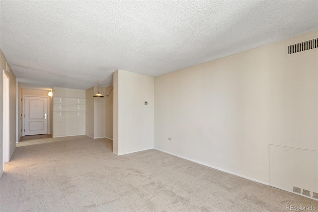 1020 15th St Unit 25D, Denver, CO 80202 - empty room featuring light colored carpet, a textured ceiling, and baseboards