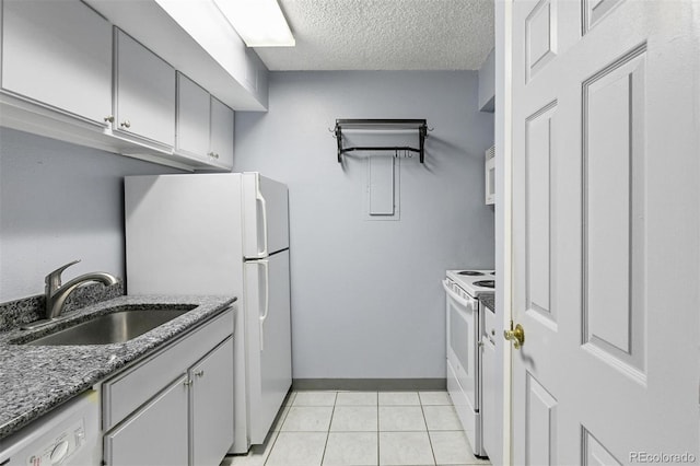 1020 15th St Unit 25D, Denver, CO 80202 - kitchen featuring white appliances, a sink, a textured ceiling, light tile patterned floors, and baseboards