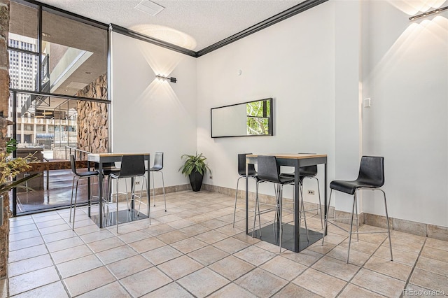 1020 15th St Unit 25D, Denver, CO 80202 - tiled dining space featuring ornamental molding, a textured ceiling, and baseboards