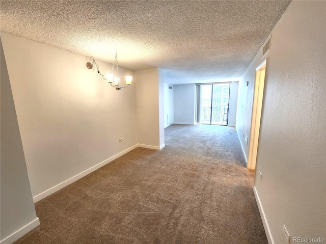 1020 15th St Unit 25D, Denver, CO 80202 - carpeted empty room with a chandelier, baseboards, and a textured ceiling