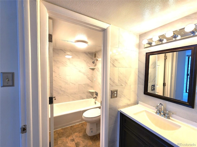 1020 15th St Unit 25D, Denver, CO 80202 - bathroom with toilet, vanity, a textured ceiling, washtub / shower combination, and tile walls
