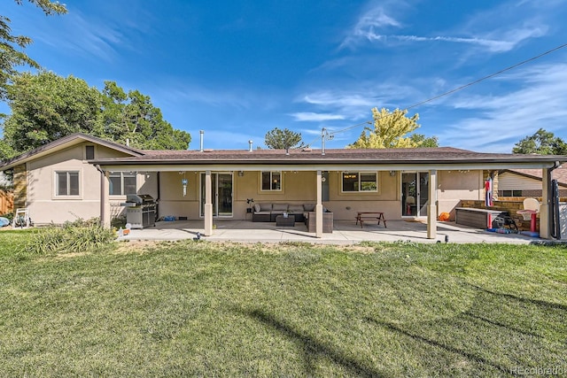 rear view of house featuring an outdoor hangout area, a patio, and a lawn