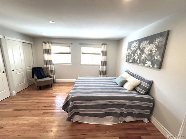 bedroom with a closet and hardwood / wood-style floors