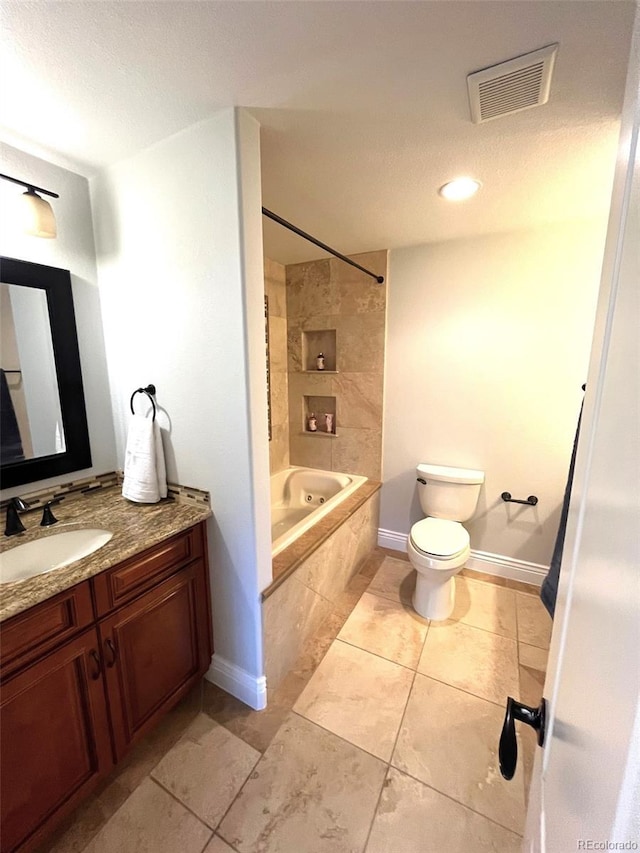 full bathroom featuring tile patterned flooring, toilet, vanity, and tiled shower / bath