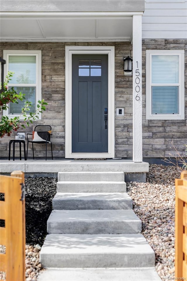 15006 Cast Pebble Cir, Parker, CO 80134 - doorway to property featuring stone siding and covered porch