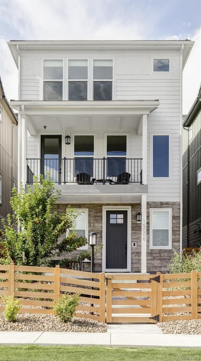 15006 Cast Pebble Cir, Parker, CO 80134 - view of front of house with a balcony, a fenced front yard, and a gate