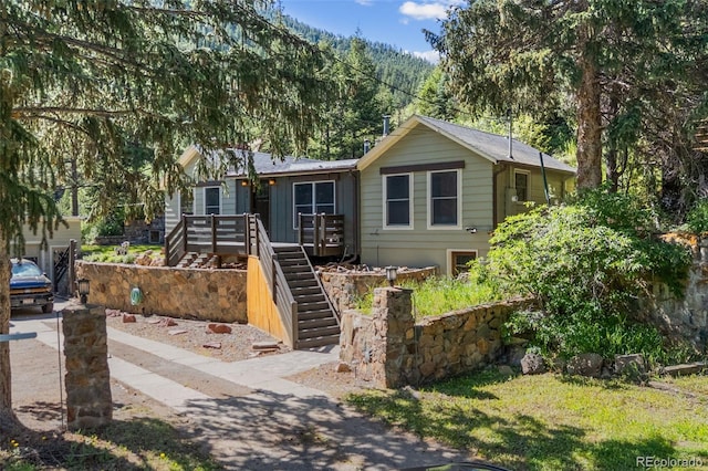 55 Two Moon Rd, Idaho Springs, CO 80452 - single story home featuring stairs and a wooden deck