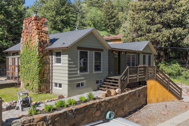 55 Two Moon Rd, Idaho Springs, CO 80452 - view of front of home with a chimney, roof with shingles, and a wooden deck