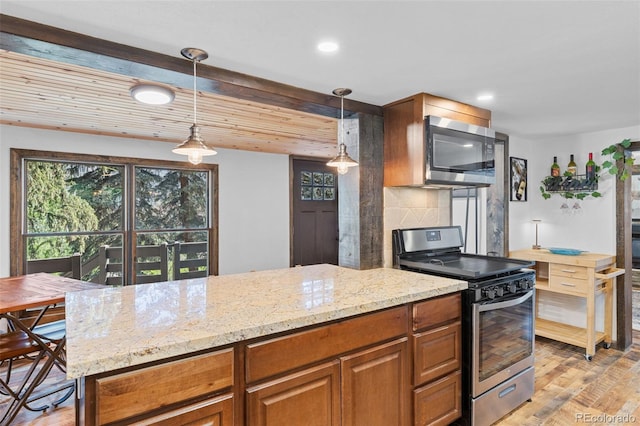 55 Two Moon Rd, Idaho Springs, CO 80452 - kitchen featuring stainless steel appliances, light stone counters, light wood-style flooring, tasteful backsplash, and pendant lighting