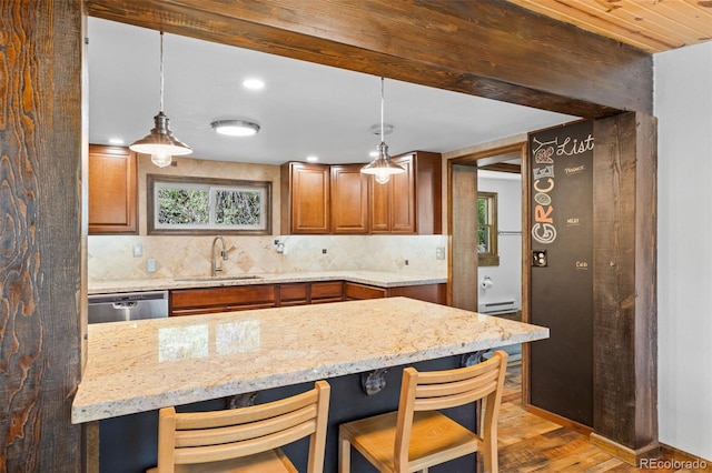 55 Two Moon Rd, Idaho Springs, CO 80452 - kitchen with dishwasher, a baseboard radiator, decorative backsplash, brown cabinets, and recessed lighting