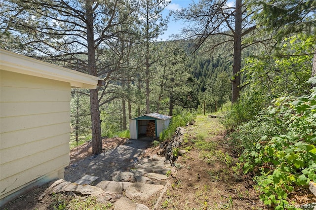 55 Two Moon Rd, Idaho Springs, CO 80452 - view of yard featuring a shed and a view of trees