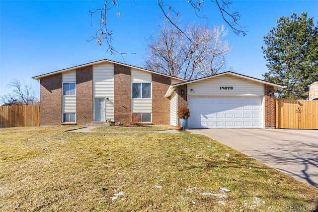 mid-century modern home with an attached garage, brick siding, fence, concrete driveway, and a front yard