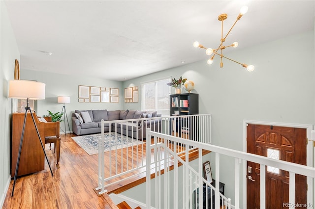 living area with wood finished floors and a notable chandelier